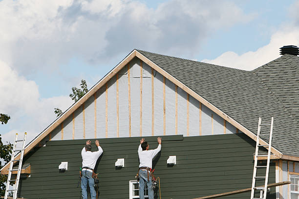 Professional Storm Damage Siding Repair technician working in Rogers, TX